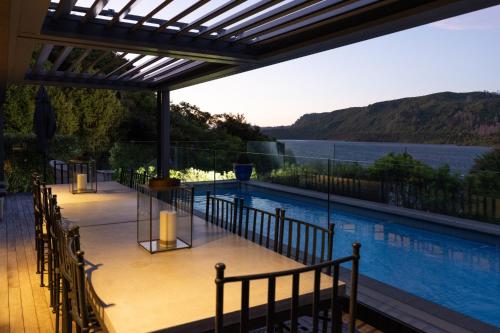a swimming pool with a view of the water at The Point Villas in Taupo