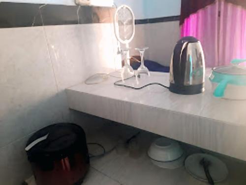 a counter with a toaster and a mirror on it at Ayunda Stay & Hostel in Airsatang