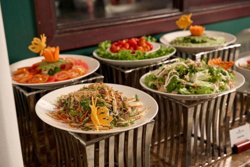 a bunch of plates of food on a buffet at Hoi An Odyssey Hotel & Spa in Hoi An