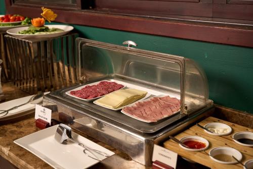 a buffet with meat and other food on a table at Hoi An Odyssey Hotel & Spa in Hoi An