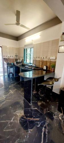 a large kitchen with a table and chairs in it at Green House Stay in Mandrem