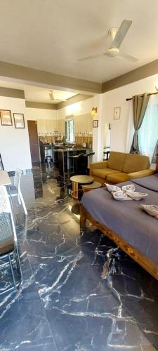 a living room with a floor covered in marble at Green House Stay in Mandrem