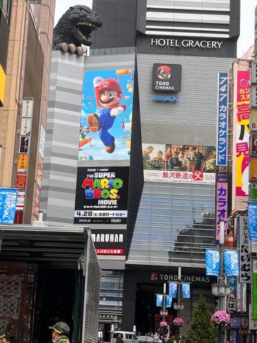 a building with signs on the side of it at Zen Japanese room up to four Shinjuku 20 minutes Walmart DonDonDonki 7 minutes from station Free parking Quiet area at Tanashi Station in Nishitokyo