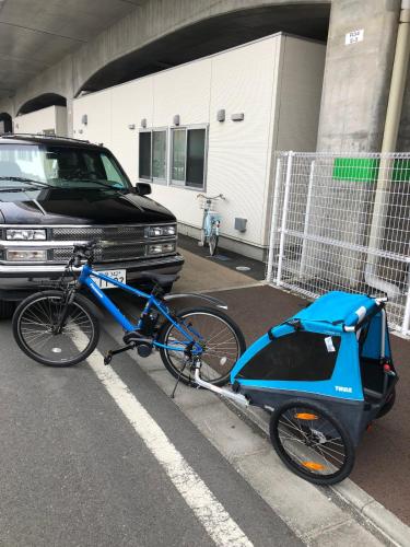 a bike with a cart parked next to a truck at Zen Japanese room up to four Shinjuku 20 minutes Walmart DonDonDonki 7 minutes from station Free parking Quiet area at Tanashi Station in Nishitokyo