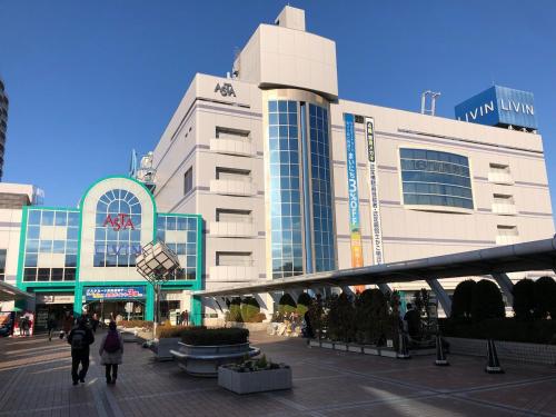 a group of people walking in front of a building at Zen Japanese room up to four Shinjuku 20 minutes Walmart DonDonDonki 7 minutes from station Free parking Quiet area at Tanashi Station in Nishitokyo