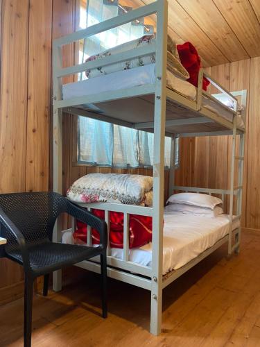 a room with two bunk beds and a chair at Lenzila Retreat in Ravangla