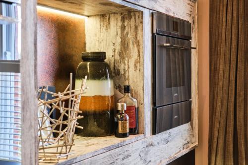 a wooden cabinet with bottles of alcohol on it at Bank House, Bushmills in Bushmills