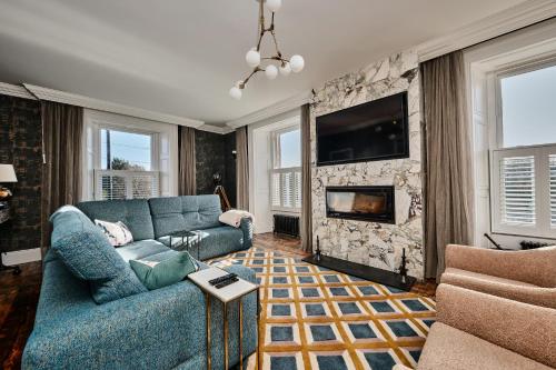 a living room with a blue couch and a fireplace at Bank House, Bushmills in Bushmills
