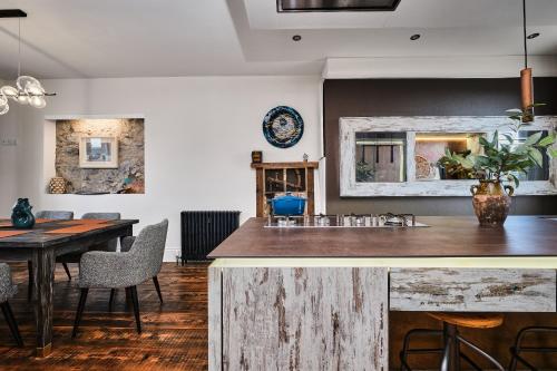 a kitchen and dining room with a table and chairs at Bank House, Bushmills in Bushmills