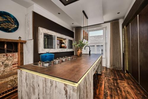 a kitchen with a wooden island with a sink at Bank House, Bushmills in Bushmills