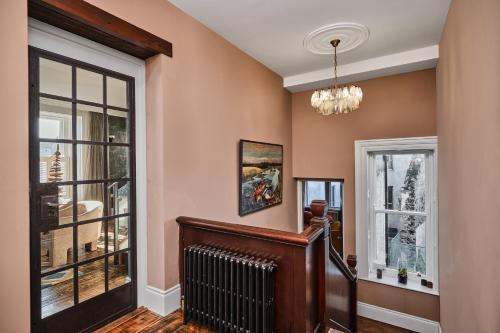 a living room with a staircase and a window at Bank House, Bushmills in Bushmills