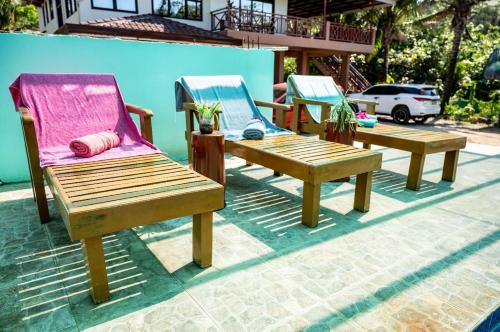 a group of three chairs sitting on a patio at La Jose Beach Resort in Pagudpud