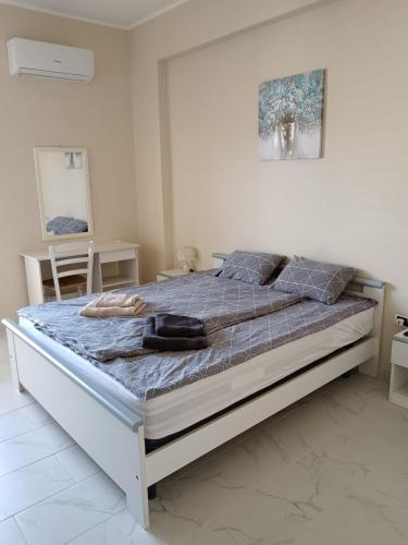 a bedroom with a large bed with a blue comforter at Diana Apartment Briatico in Briatico