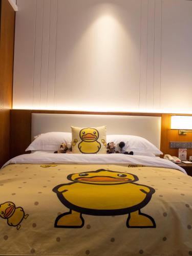 a bedroom with a bed with a yellow bowl on it at Shangrao International Hotel in Shangrao