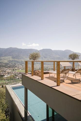 a balcony of a house with a swimming pool at Residence Aqualis in Marlengo