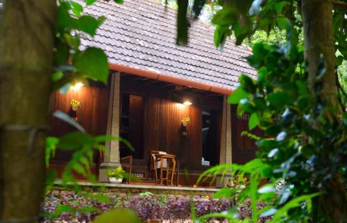 a house with a table and chairs in front of it at Swasthi Serviced Villa in Kanjirapalli