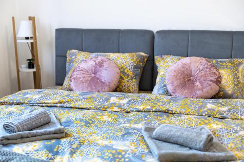 a bed with pillows and towels on top of it at Lana Lux 19 in Subotica