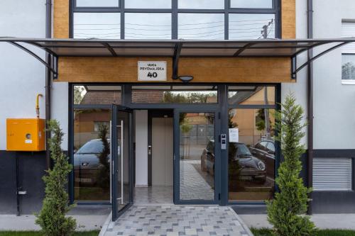 an entrance to a building with cars parked at Lana Lux 19 in Subotica
