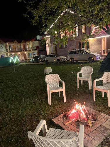 a group of chairs around a fire pit at night at Birdsong Pahalgam in Pahalgām