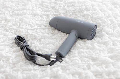 a wiimote laying on top of a bed at Kstyle Apartments UNO in Tamano