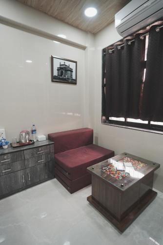 a living room with a couch and a table at Hotel Jupiter Residency in Mumbai