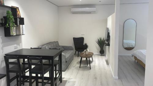 a living room with a table and a couch at שלווה במעיינות in Bet Sheʼan