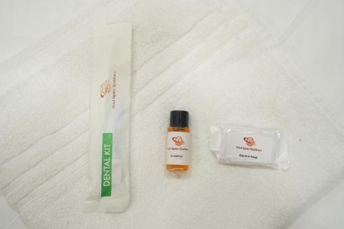 a tube of toothpaste and a bottle of sunscreen at Hotel Jupiter Residency in Mumbai