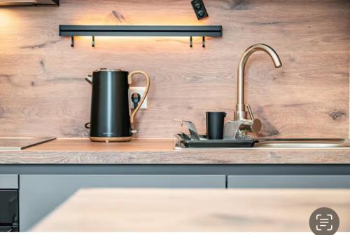 a kitchen counter with a sink with two cups on it at Casa Caso in Achim