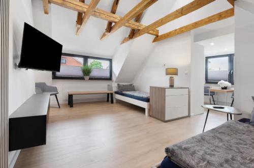 a bedroom with a bed and a tv in a room at Casa Caso in Achim