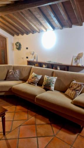 a couch in a living room with pillows on it at La loggia sulle Apuane in Tresana