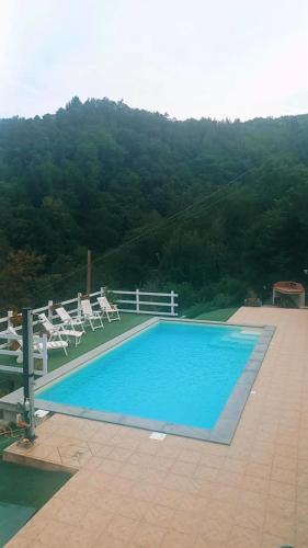 a swimming pool with lounge chairs at La loggia sulle Apuane in Tresana