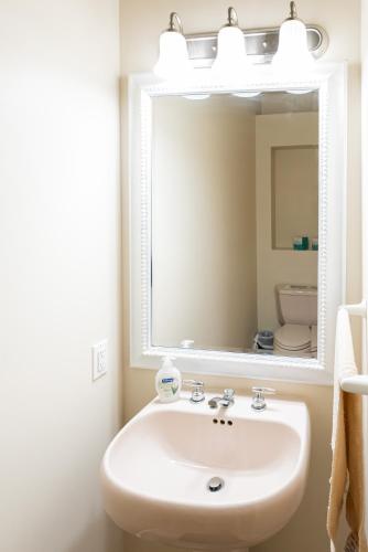 a bathroom with a sink and a mirror at Golden Sands Emerald - Florida's Best - ALL Private Beachfront Estate with TENNIS-PICKLEBALL Court, Pool, Spa in Indialantic
