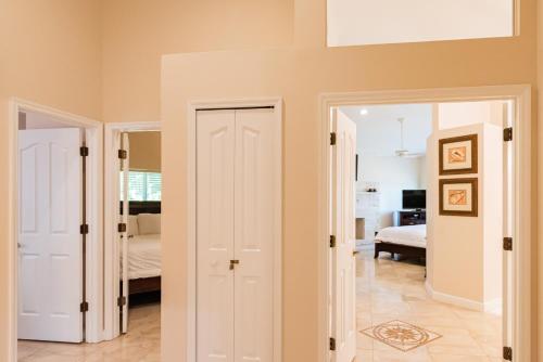 a room with a door leading to a bedroom at Golden Sands Emerald - Florida's Best - ALL Private Beachfront Estate with TENNIS-PICKLEBALL Court, Pool, Spa in Indialantic