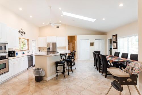 a kitchen and dining room with a table and chairs at Golden Sands Emerald - Florida's Best - ALL Private Beachfront Estate with TENNIS-PICKLEBALL Court, Pool, Spa in Indialantic