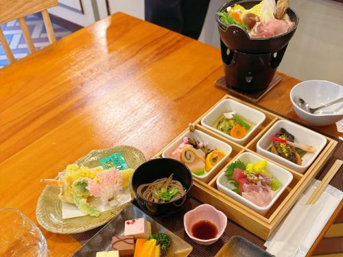 a wooden table with a tray of food on it at Hakuba Sun Valley Hotel in Hakuba