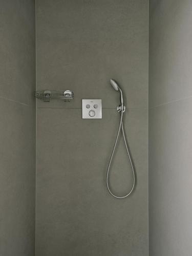 a shower with a hose attached to a wall at Art Apartments in Berlin