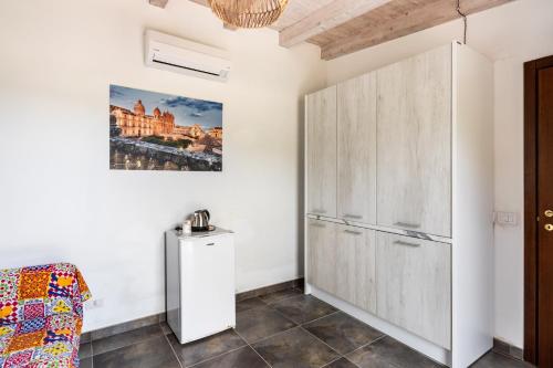a room with a white cabinet and a couch at Agriturismo Alle Riserve Cavagrande in Avola