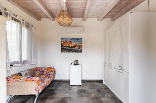 a living room with a couch and a refrigerator at Agriturismo Alle Riserve Cavagrande in Avola