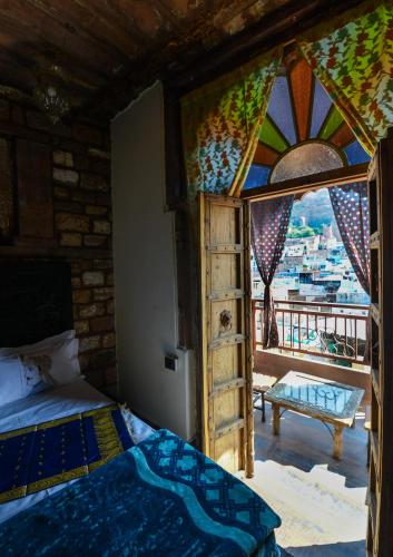 a bedroom with a bed and a window with a view at Castle View Haveli in Jodhpur