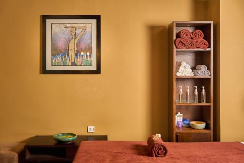 a room with a table and a picture on the wall at Hoi An Odyssey Hotel & Spa in Hoi An