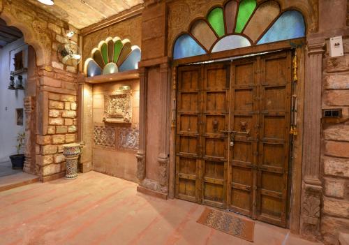an entrance to a building with a large wooden door at Castle View Haveli in Jodhpur