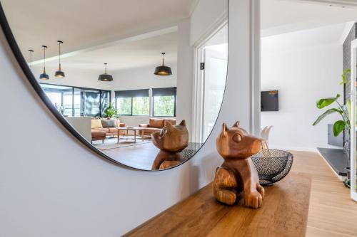 a living room with a large mirror on the wall at Driftaway, Albany in Albany