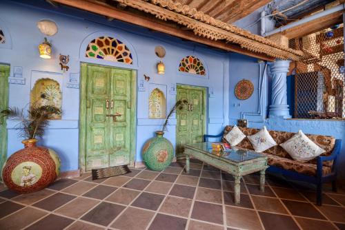 a living room with green doors and a couch at Castle View Haveli in Jodhpur