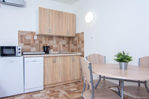 a kitchen and dining room with a table and a refrigerator at Penzion Anareta in Frýdek-Místek
