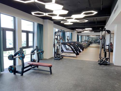 a gym with rows of treadmills and machines at Shangrao International Hotel in Shangrao