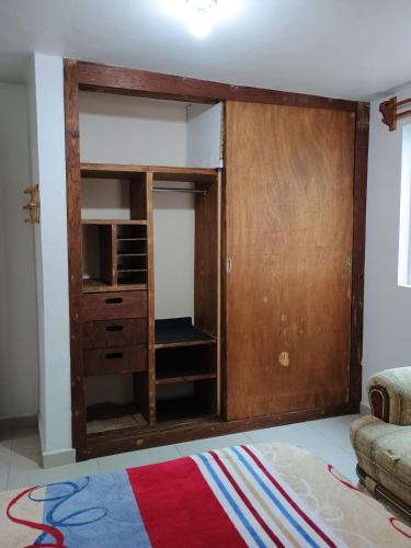 a room with a closet with a wooden door at Your space, your home in Cedro