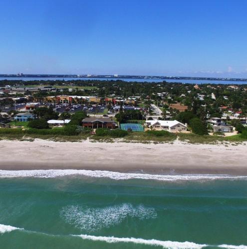 an aerial view of a beach with houses and the ocean at Golden Sands Emerald - Florida's Best - ALL Private Beachfront Estate with TENNIS-PICKLEBALL Court, Pool, Spa in Indialantic