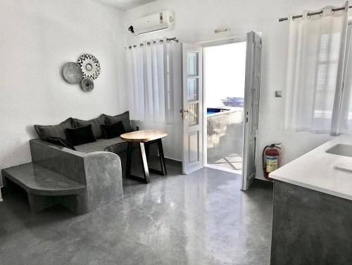 a living room with a couch and a table at Vallais Villa in Imerovigli