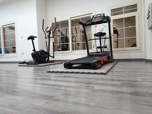 a gym with two exercise bikes in a room at Grand Room in Sheikh Zayed