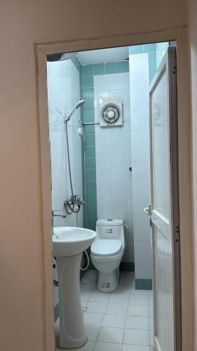 a bathroom with a toilet and a sink at Middle East Building in Salalah